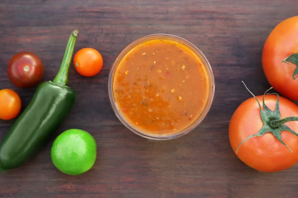 stock image Tasty salsa sauce and ingredients on wooden table, flat lay