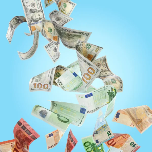 stock image Money exchange. Dollars turning into euro banknotes while falling on light blue background