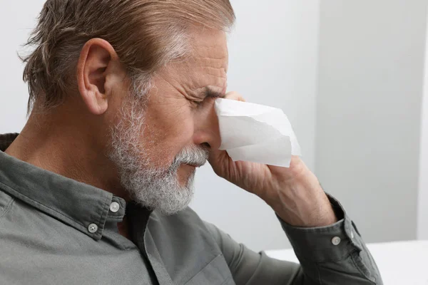 stock image Upset senior man wiping tears with napkin at home, closeup. Loneliness concept