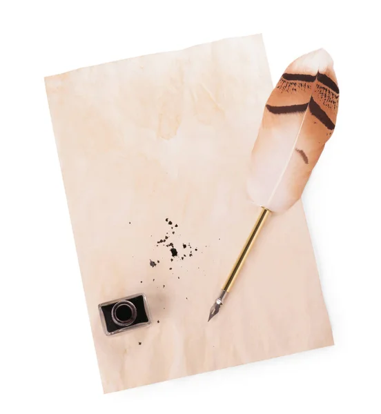 Parchment with stains of ink, feather pen and inkwell on white background, top view