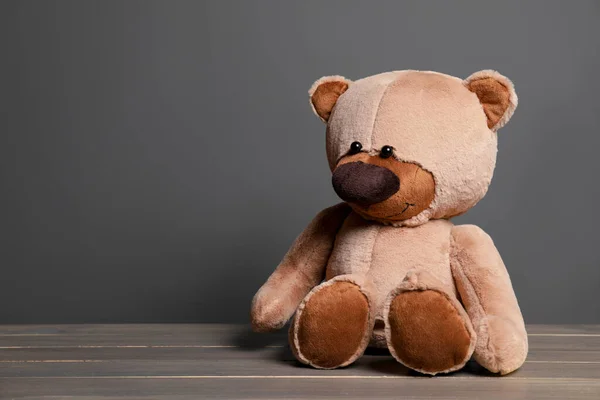Cute Teddy Bear Wooden Table Black Wall Space Text — Stock Photo, Image