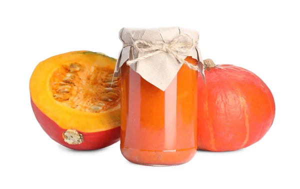 stock image Jar of pumpkin jam and fresh pumpkins on white background