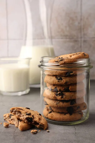 Glass Jar Delicious Chocolate Chip Cookies Milk Grey Table — Stock Photo, Image