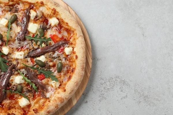 stock image Tasty pizza with anchovies, arugula and olives on grey table, top view. Space for text