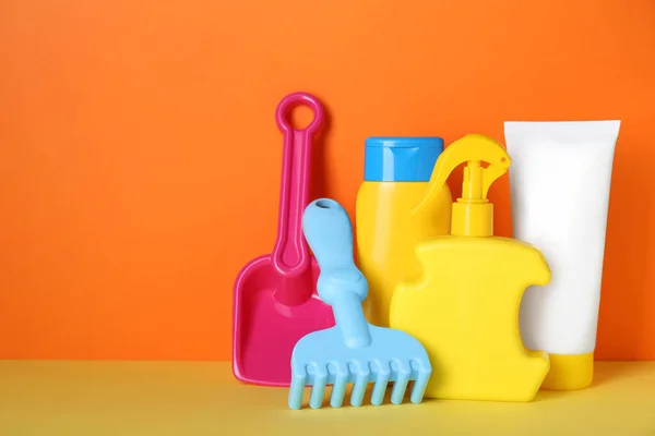 Different Suntan Products Plastic Beach Toys Color Background Space Text — Stockfoto