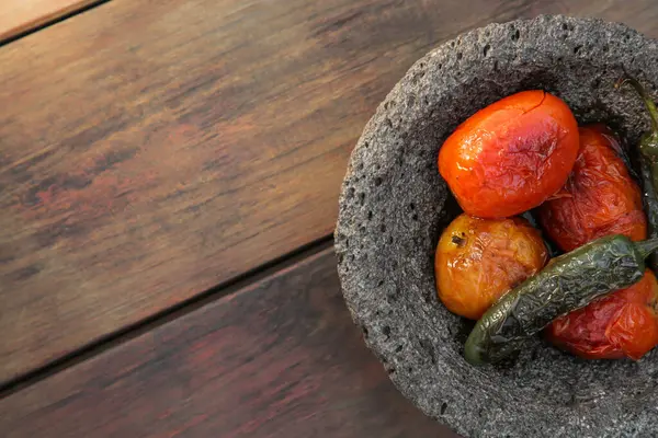 stock image Ingredients for salsa sauce in stone bowl on wooden table, top view. Space for text