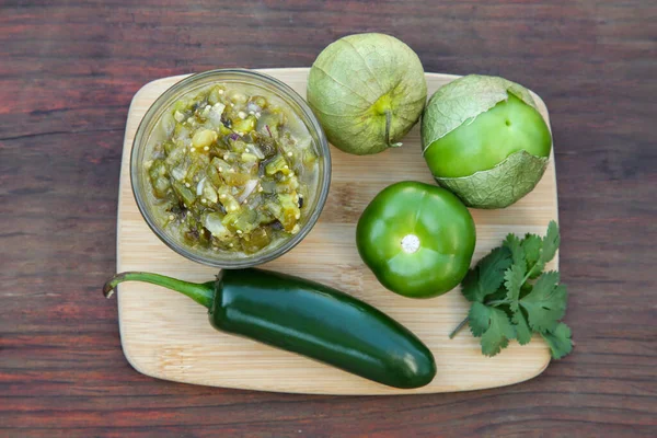 stock image Tasty salsa sauce and ingredients on wooden table, top view