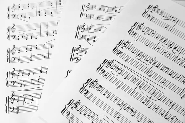 Μουσικά Σεντόνια Μελωδίες Γραμμένες Διαφορετικά Μουσικά Σύμβολα Φόντο Κοντινό Πλάνο — Φωτογραφία Αρχείου