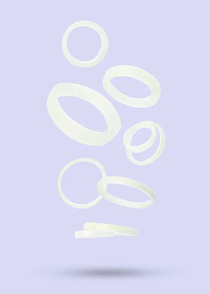 Many Onion Rings Falling Pastel Light Violet Background — Stock Photo, Image