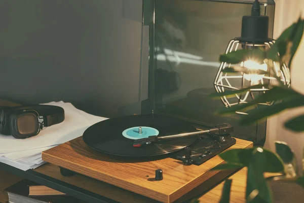 stock image Stylish turntable with vinyl record on table indoors