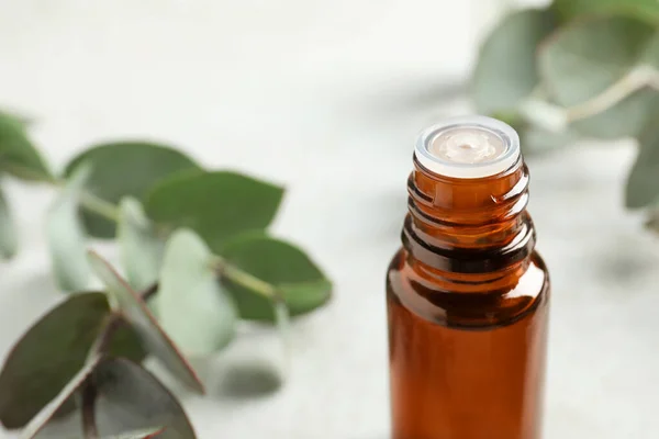 Bottle Eucalyptus Essential Oil Leaves White Table Closeup Space Text — Stock Photo, Image