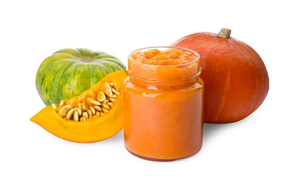 stock image Jar of pumpkin jam and fresh pumpkins on white background