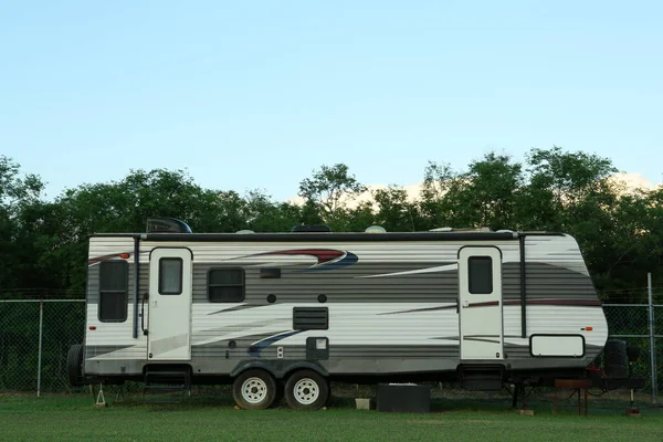 stock image Travel trailer parked outdoors. Home on wheels