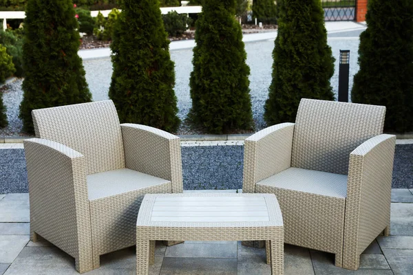 stock image Comfortable armchairs and coffee table outdoors. Beautiful rattan garden furniture