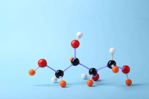 Molecule of sugar on light blue background. Chemical model