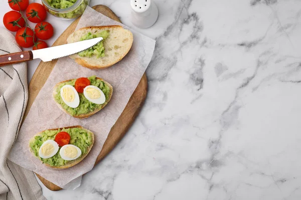 Heerlijke Sandwiches Met Guacamole Eieren Tomaten Witte Marmeren Tafel Plat — Stockfoto