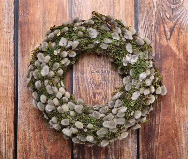 stock image Wreath made of beautiful willow flowers on wooden table, top view