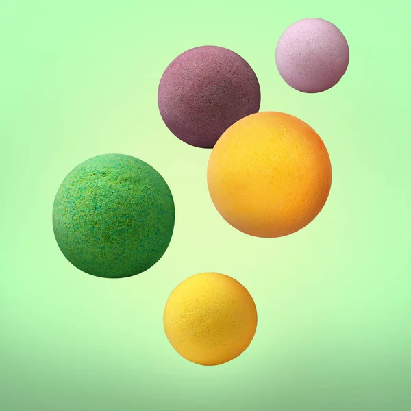 Many Different Bath Bombs Falling Light Green Background — Stock Photo, Image