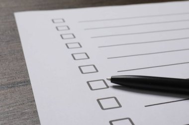 Kağıt kağıtlar, karton kutular ve tahta masa üzerinde kalem, yakın plan. Kontrol Listesi