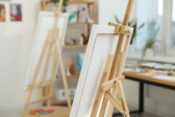 Wooden easel with canvas in artist\'s studio. Creative hobby