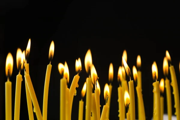 Many Burning Church Candles Black Background — Stock Photo, Image