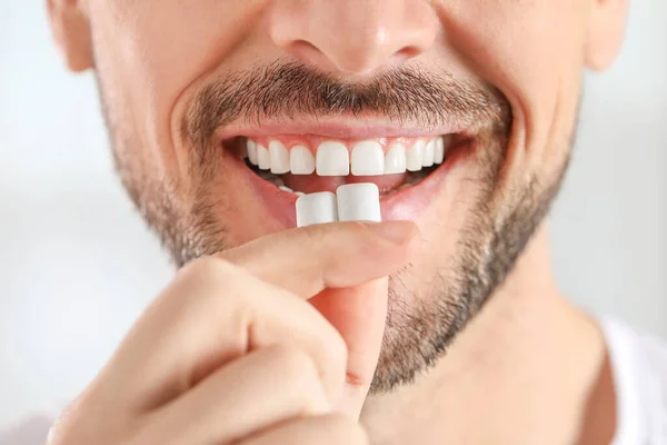 Man Putting Chewing Gums Mouth Light Background Closeup — Stock Photo, Image