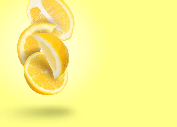 Cut Fresh Lemons Falling Light Yellow Background Space Text — Stock Photo, Image