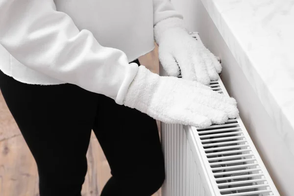 Girl Warming Hands Heating Radiator Indoors Closeup — Fotografia de Stock