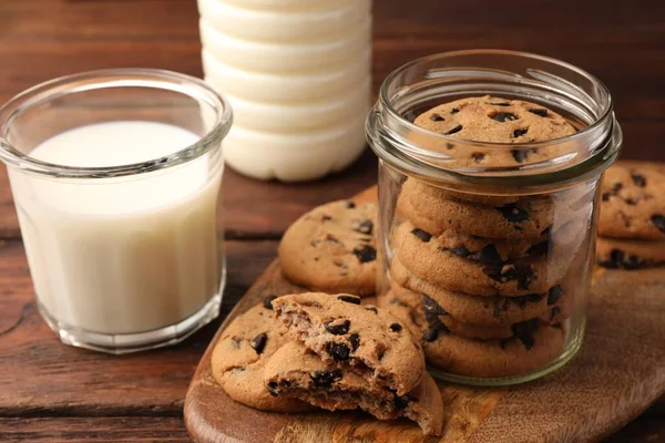 Glass Jar Delicious Chocolate Chip Cookies Milk Wooden Table Closeup — Stock Photo, Image