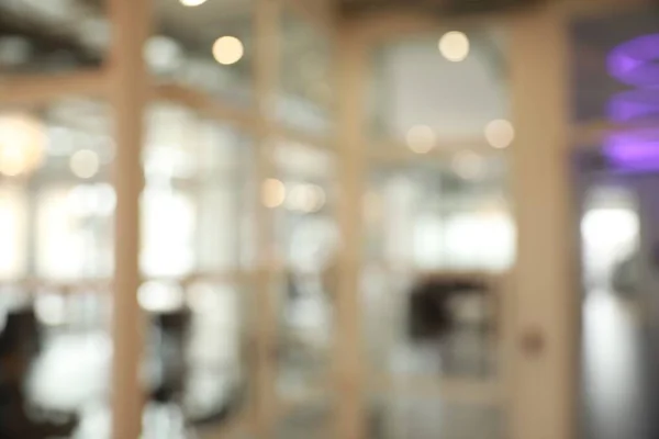 stock image Blurred view of empty conference room and glass door in office