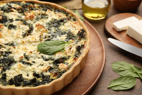 stock image Delicious homemade spinach quiche on wooden board, closeup