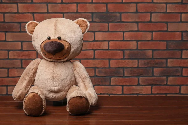 Cute Teddy Bear Wooden Table Brick Wall Space Text — Stock Photo, Image