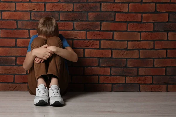 Upset Boy Sitting Floor Brick Wall Space Text Children Bullying — Fotografia de Stock