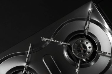 Portable gas stove on black background, top view. Military equipment