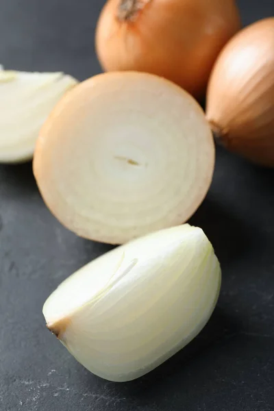 Whole Cut Onions Black Textured Table Closeup — Fotografia de Stock