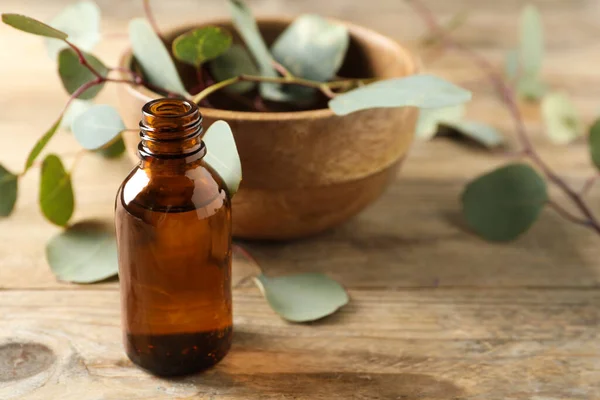 Bottle Eucalyptus Essential Oil Leaves Wooden Table Space Text — Stock Photo, Image