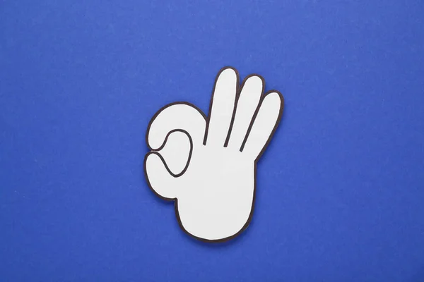 Paper Cutout Okay Hand Gesture Blue Background Top View — Stock Photo, Image