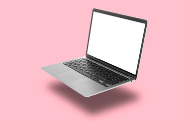 Pembe arka planda uçan modern bir laptop.