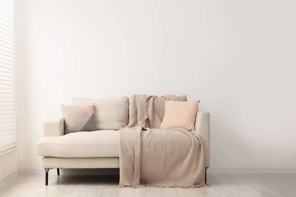 Oturma Odasında Yastıklı Battaniyeli Rahat Bir Kanepe Tasarım — Stok fotoğraf