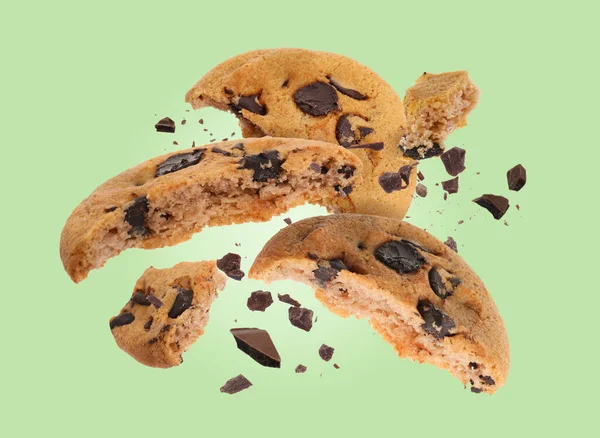 Tasty Chocolate Chip Cookies Falling Pastel Green Background — Stock Photo, Image