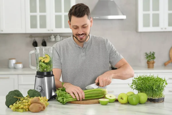 Happy Man Cutting Celery Delicious Smoothie White Marble Table Kitchen — Stock Photo, Image