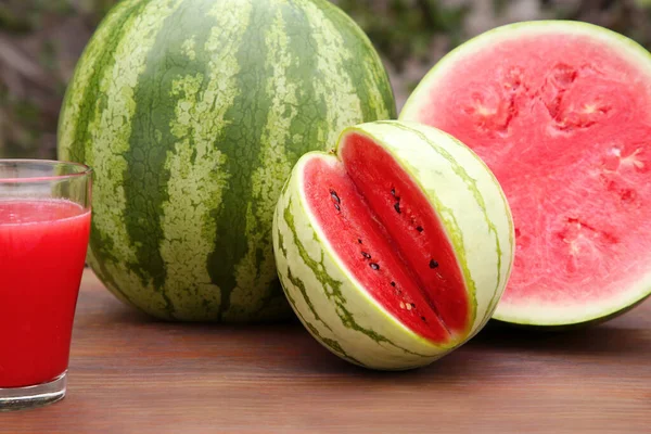 Delicious Ripe Watermelons Glass Fresh Juice Wooden Table Outdoors — Stock Photo, Image
