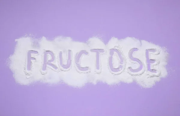 stock image Word Fructose made of powder on violet background, flat lay