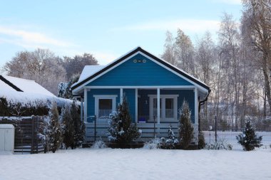 Winter landscape with beautiful house, trees and bushes in morning