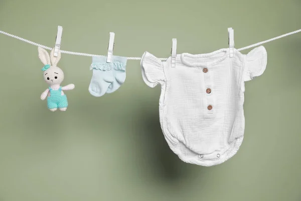 Cute Small Baby Clothes Toy Hanging Washing Line Green Background — Stock Photo, Image