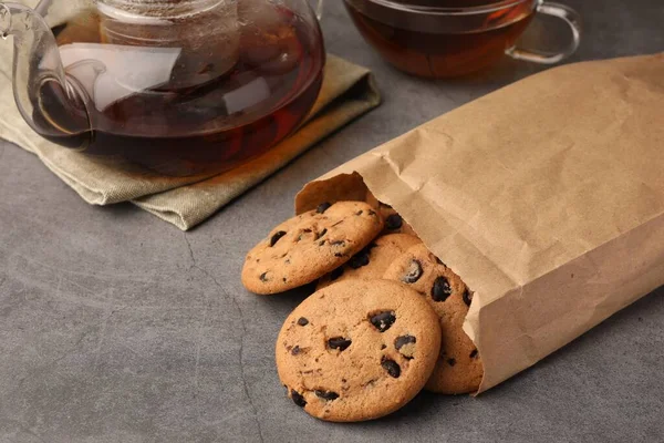 Paper Bag Delicious Chocolate Chip Cookies Tea Grey Table Closeup — Stock Photo, Image