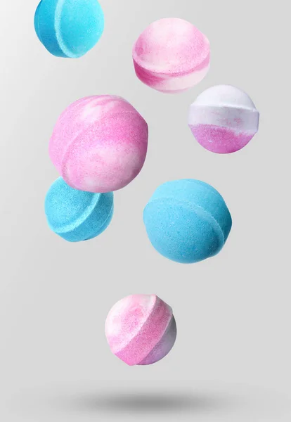 Many Different Bath Bombs Falling Light Grey Background — Stock Photo, Image