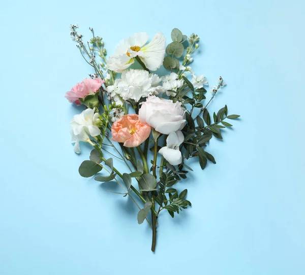Different beautiful flowers on light blue background, flat lay