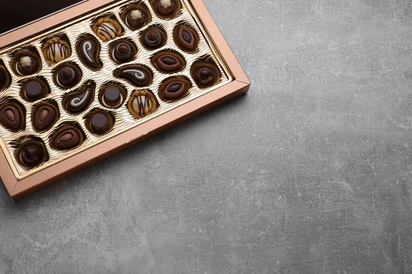 stock image Box of delicious chocolate candies on light grey table