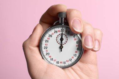 Woman holding vintage timer on pink background, closeup clipart